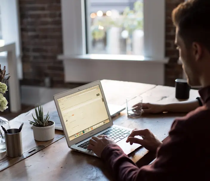 Man using a computer while sitting at a desk